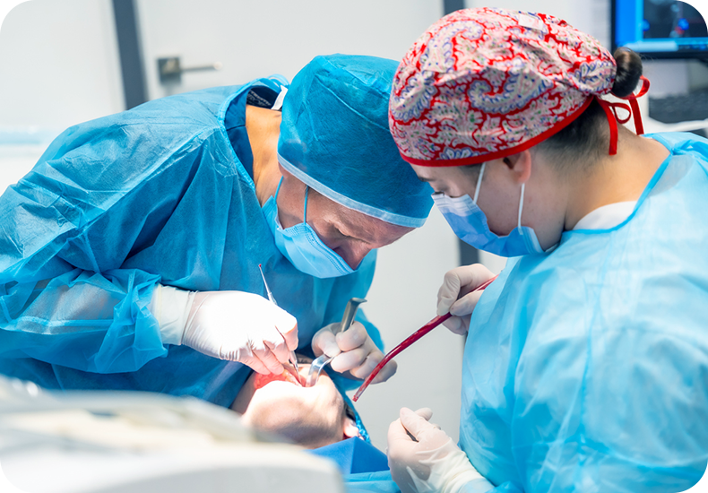 Dentists performing on patient.